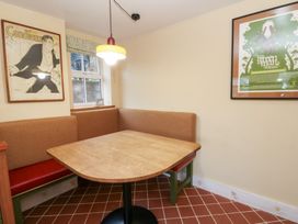 A dining area with a table and benches at Fronglyd in Aberporth