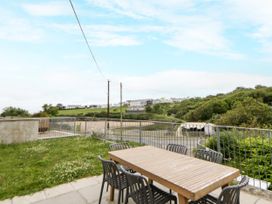 An outdoor area with a table and chairs at Fronglyd Aberporth