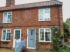 A brick exterior of a house with windows and a front door at Beeble Cottage in Fakenham