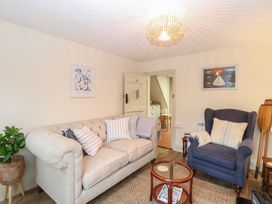 A living room with a sofa and armchair at Beeble Cottage in Fakenham