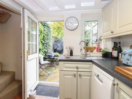 A kitchen with a door leading to the garden at Beeble Cottage in Fakenham