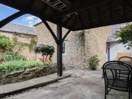 An outdoor area with a patio and garden at Vine Cottage, Burton Bradstock