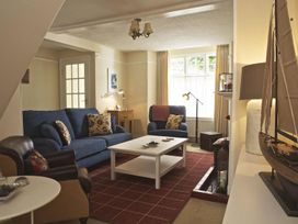 A living room with a sofa and coffee table at St Leonards in Salcombe