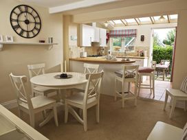 A dining room with a table and chairs at St Leonards in Salcombe