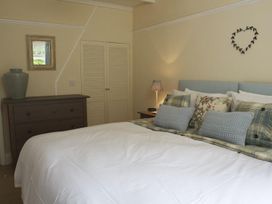 A bedroom with a bed and dresser at St Leonards in Salcombe