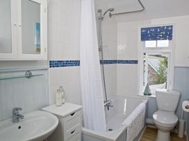 A bathroom with a bathtub and shower at St Leonards in Salcombe