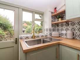 A kitchen with sink and wooden countertop at 29 Spring Street Chipping Norton