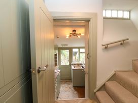 A kitchen with a door and staircase at 29 Spring Street in Chipping Norton