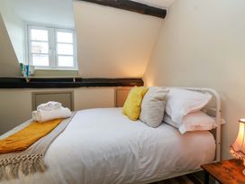 A bedroom with a bed and window at 29 Spring Street in Chipping Norton