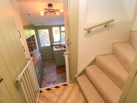 A kitchen with a sink and stairs at 29 Spring Street Chipping Norton