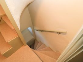 A staircase with carpet and handrail at 29 Spring Street in Chipping Norton