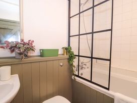 A bathroom with a bathtub and shower at 6 Priory Lane Burford