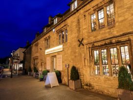 A building exterior with windows and signage at 6 Priory Lane in Burford