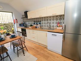 A kitchen with cabinets, sink, and table at 6 Priory Lane Burford