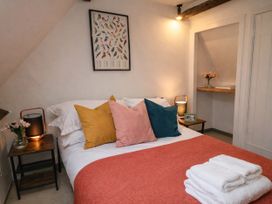 A bedroom with a bed and nightstand at Burford Apple in Burford
