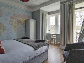 A bedroom with a map on the wall and a desk at Roselyn House in Par