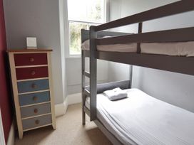 A bedroom with a bunk bed and a chest of drawers at Roselyn House in Par