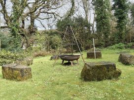 An outdoor space with a fire pit and stone seating at Roselyn House in Par