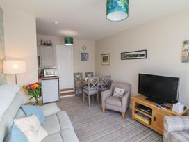 A living room with a sofa and dining area at Farriers Yard in Whitby