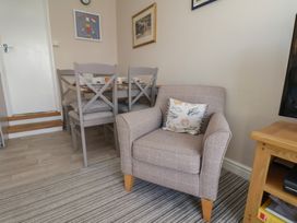A dining room with a table and chairs at Farriers Yard in Whitby