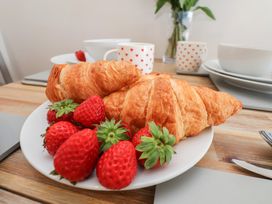 A plate with croissants and strawberries at Farriers Yard Whitby