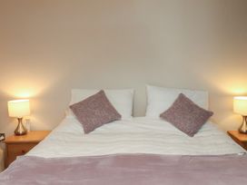A bedroom with a bed and lamps at Farriers Yard in Whitby