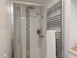 A bathroom with a shower and towel rail at Farriers Yard in Whitby