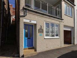 A front entrance with blue door and balcony at Farriers Yard in Whitby