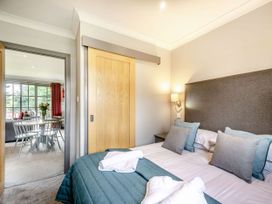 A bedroom with a bed and door leading to another room at Bargany in Girvan