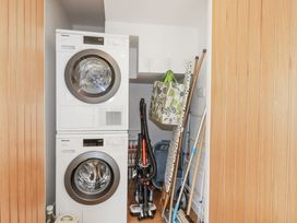 A laundry room with a washing machine and tumble dryer at Hillbre in Trevone