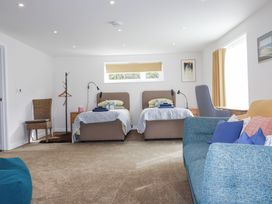 A bedroom with two beds and a sofa at Hillbre Trevone