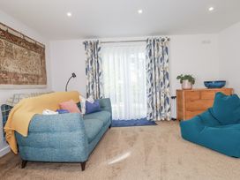 A living room with a sofa and curtains at Hillbre in Trevone