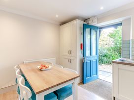 A kitchen with a table and chairs at Summerleaze Cottage 2 Spa in Bude