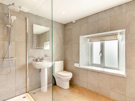 A bathroom with a shower and sink at Summerleaze Cottage 2 Spa in Bude