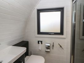 A bathroom with a sink, toilet, and shower at Garden Lodge 1 in Swansea