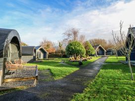 An outdoor area with cabins and pathway at Garden Lodge 1 in Swansea