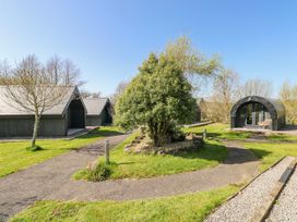 An outdoor view of cabins and landscaped area at Glamping Pod 1, Oldwalls, Llanrhidian, Gower