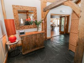 An entrance hall with a wooden counter and a lamp at Glamping Pod 1 Oldwalls, Llanrhidian, Gower