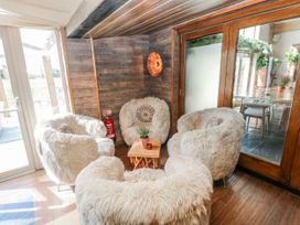 A seating area with circular chairs and a table at Glamping Pod 1 Oldwalls, Llanrhidian, Gower