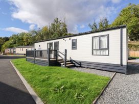 A mobile home with a deck and steps at Altair Lodge