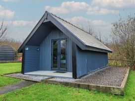 A cabin with a gravel path and grass area at Garden lodge 3 Swansea