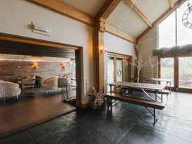 A dining area with a table and chairs at Garden lodge 3 Swansea