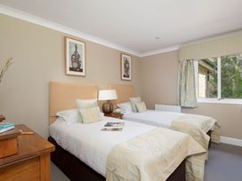 A bedroom with two single beds and a window at The Allensford in Slaley