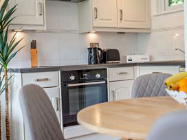 A kitchen with an oven and kettle at Kernow Nook Spa in Perranporth