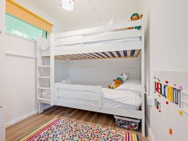A bedroom with a bunk bed and toys at Kernow Nook Spa in Perranporth