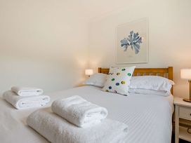 A bedroom with towels on the bed at Kernow Nook Spa in Perranporth