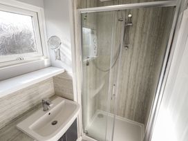 A bathroom with a shower and sink at No.49 Cherry Park Chapel St Leonards