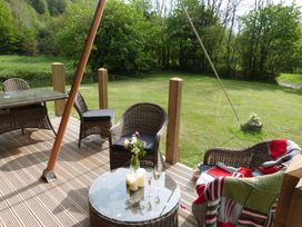 An outdoor patio with chairs and a table at Ceri in Newcastle Emlyn