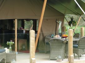 An outdoor dining area with a table and chairs at Ceri in Newcastle Emlyn