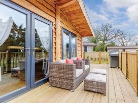 A deck with seating and sliding doors at Typhoon Lodge in Winchester